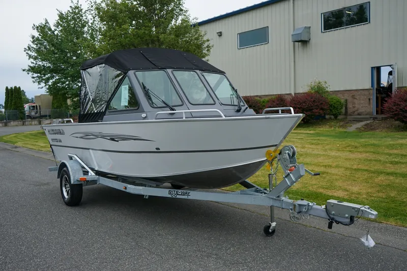 The Image of 2026 Alumaweld Stryker Sport 202 boat on trailer, parked outdoors near a building. - 1
