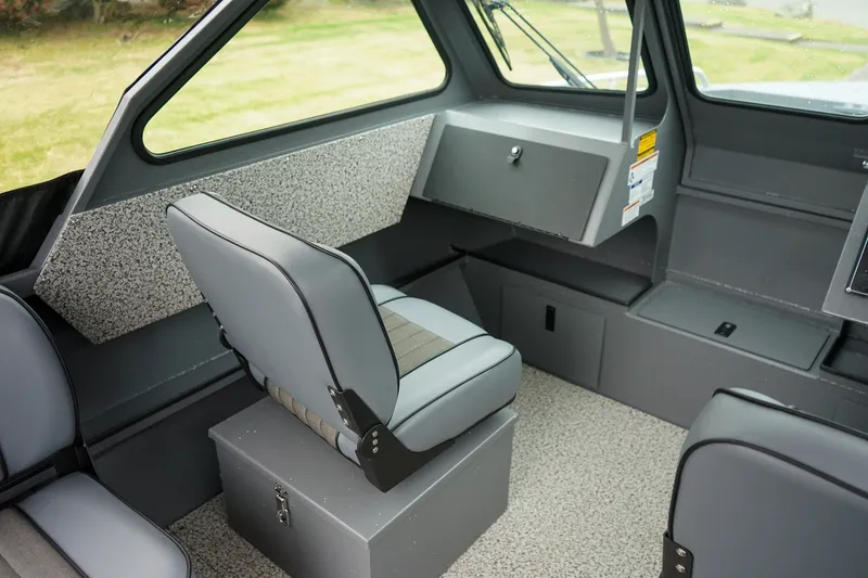 Slide: The Image of Interior of 2026 Alumaweld Stryker Sport 202 boat, featuring gray seating and storage compartments. - 13