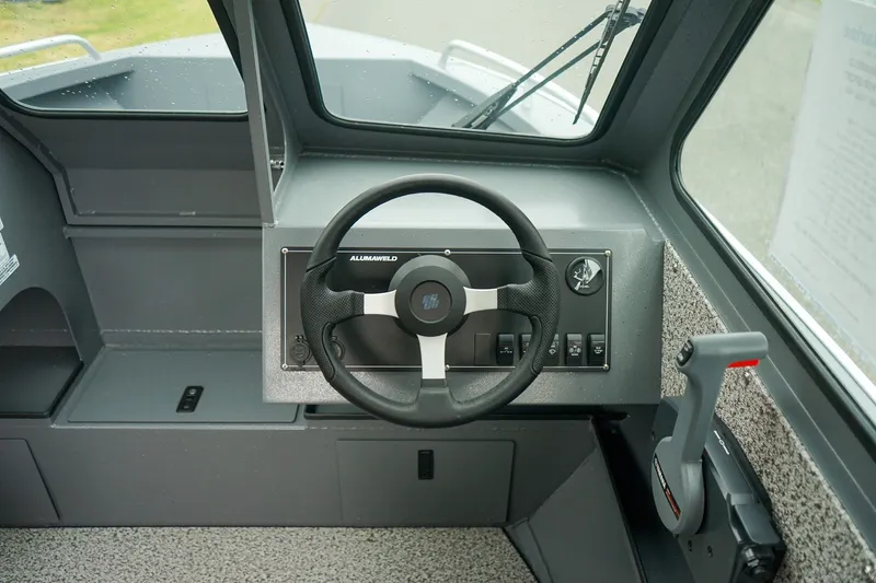 Slide: The Image of 2026 Alumaweld Stryker Sport 202 boat dashboard with steering wheel and controls. - 12