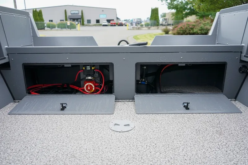 Slide: The Image of 2026 Alumaweld Stryker Sport 202 boat storage compartments with wiring and equipment. - 7