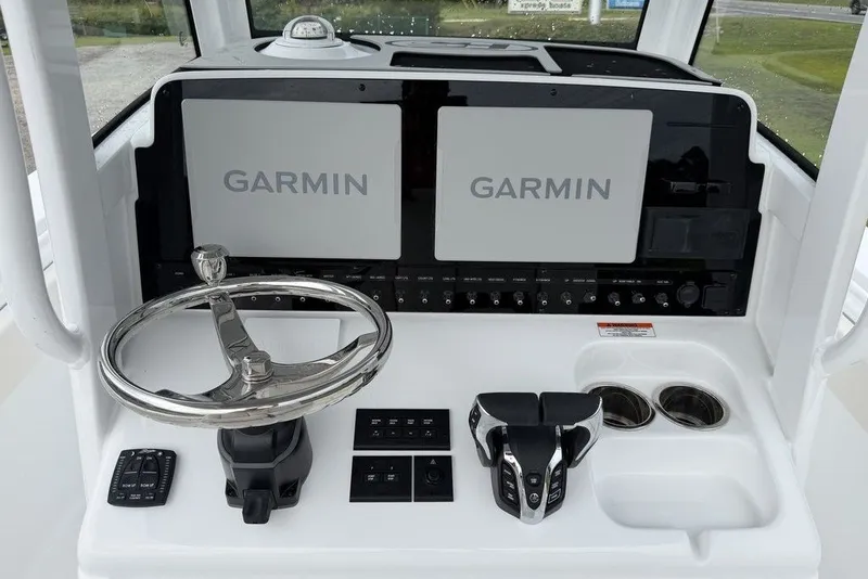 Slide: The Image of Helm of 2027 Sea Hunt Ultra 265 SE with dual Garmin displays and controls. - 9