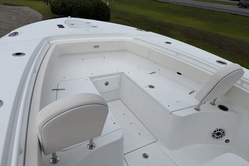 Slide: The Image of 2027 Sea Hunt Ultra 265 SE boat interior with white seating and spacious deck. - 12