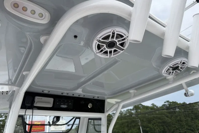 Slide: The Image of Interior view of 2027 Sea Hunt Ultra 265 SE boat, featuring speakers and rod holders. - 14