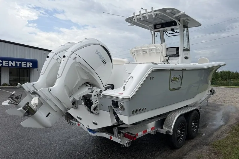 Slide: The Image of 2027 Sea Hunt Ultra 265 SE boat on trailer with dual Yamaha engines. - 6