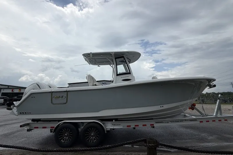 Slide: The Image of 2027 Sea Hunt Ultra 265 SE boat on trailer, under cloudy sky. - 3