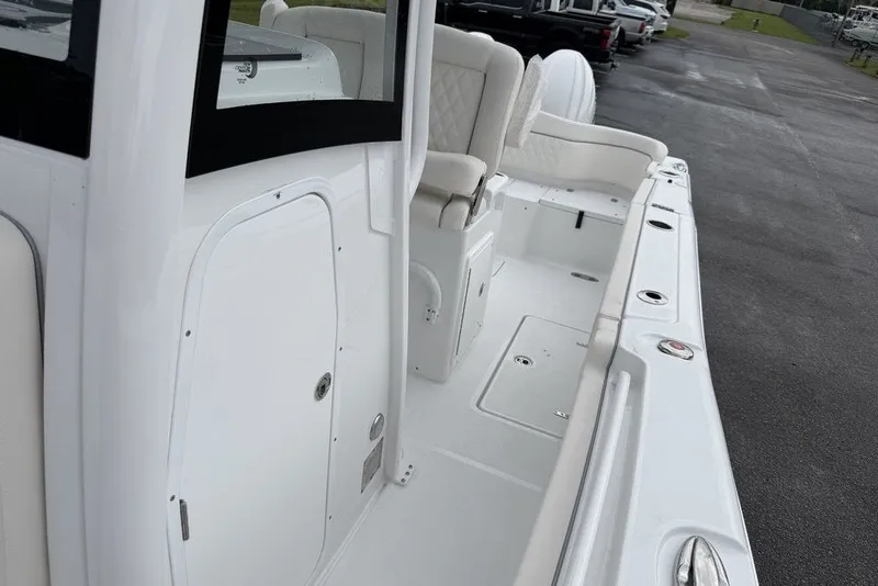 Slide: The Image of 2027 Sea Hunt Ultra 265 SE boat interior with white seating and storage compartments. - 11
