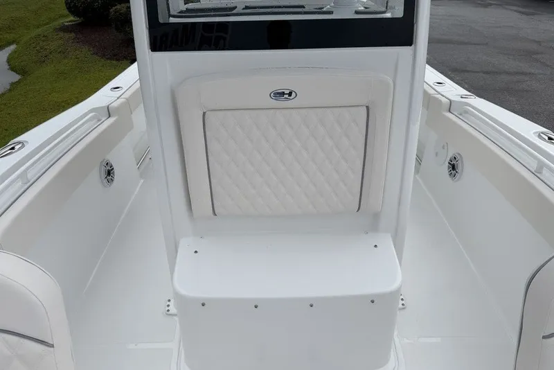 Slide: The Image of 2027 Sea Hunt Ultra 265 SE boat interior with white cushioned seating and sleek design. - 5