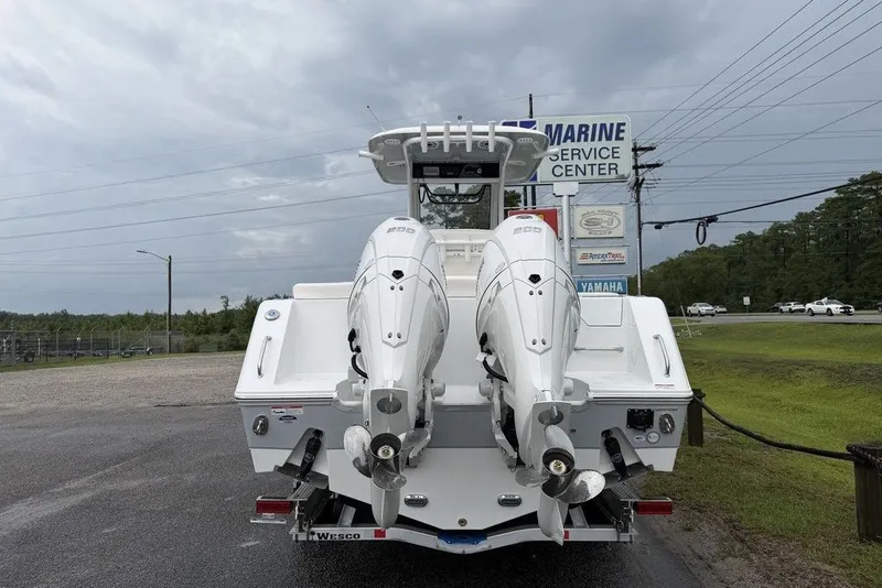 Slide: The Image of 2027 Sea Hunt Ultra 265 SE boat with dual engines at a marine service center. - 7
