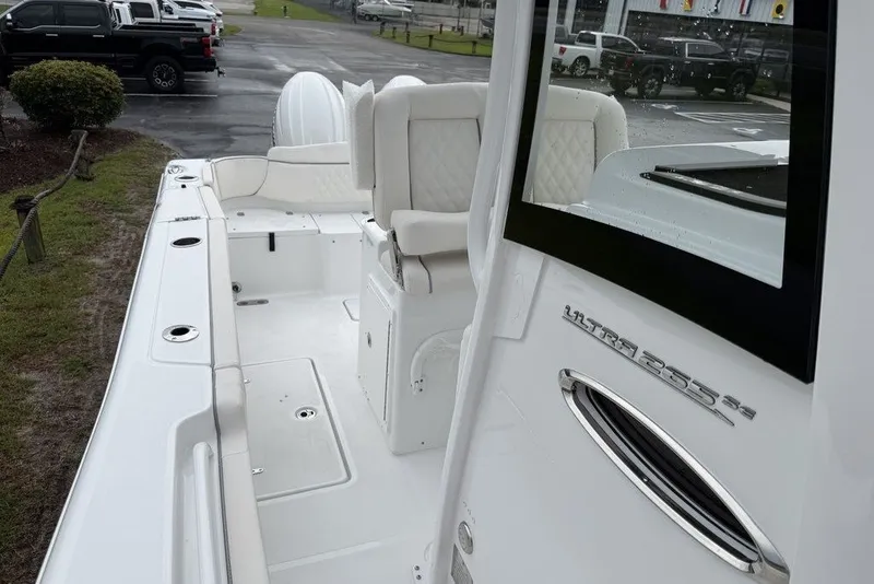 Slide: The Image of 2027 Sea Hunt Ultra 265 SE boat interior with white seating and sleek design. - 15