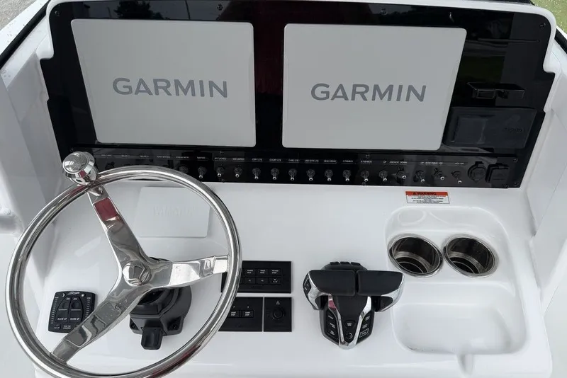 Slide: The Image of 2027 Sea Hunt Ultra 265 SE dashboard with dual Garmin displays and steering wheel. - 16