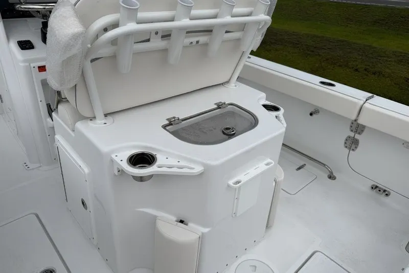 Slide: The Image of 2027 Sea Hunt Ultra 265 SE boat interior with rod holders and storage compartments. - 13