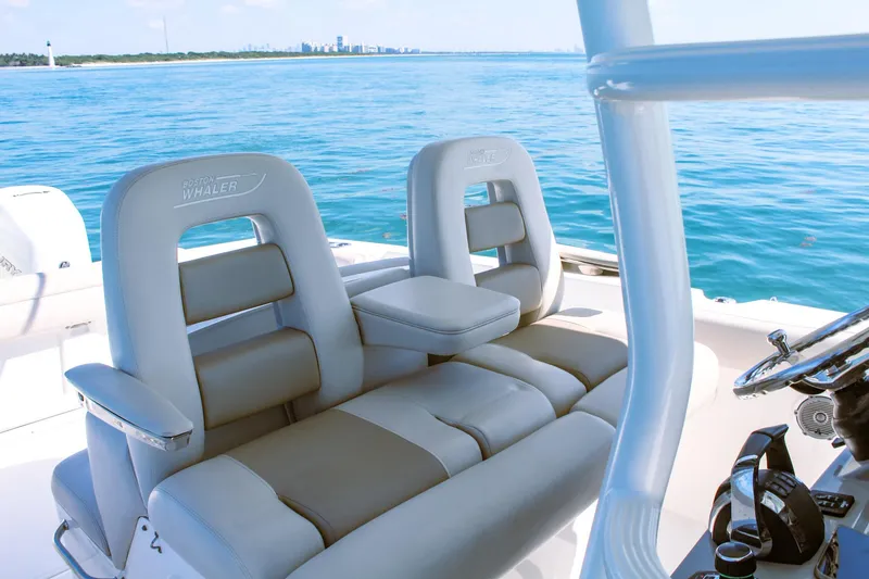 Slide: The Image of Boston Whaler 330 Outrage 2017 boat interior with luxurious seating on open water. - 4