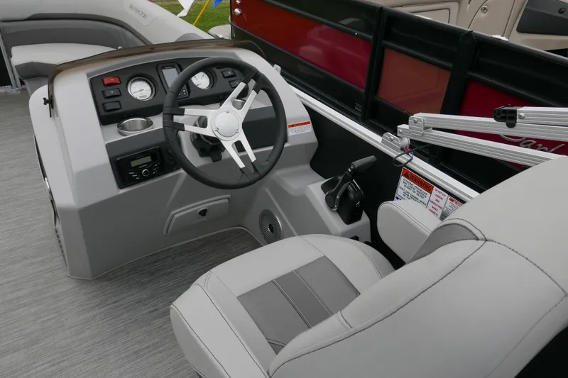 Slide: The Image of 2023 Bennington 21 SXSRC boat helm with steering wheel and control panel. - 9