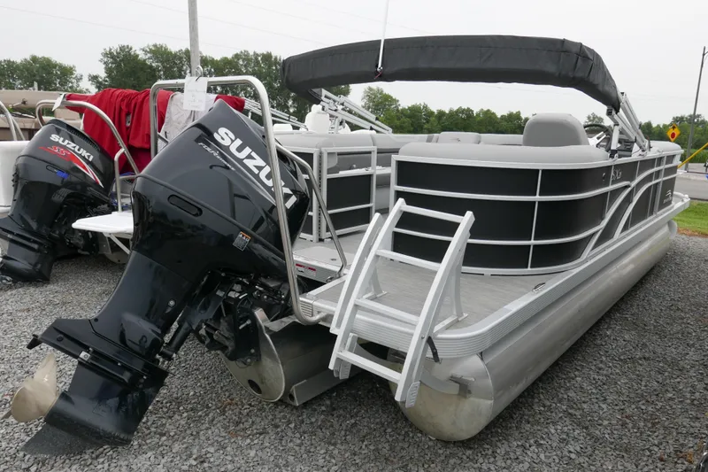 Slide: The Image of 2023 Bennington 21 SXSRC pontoon boat with Suzuki outboard motor, displayed on gravel. - 3
