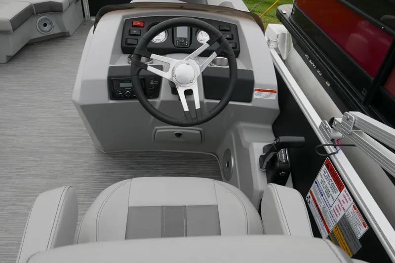 Slide: The Image of 2023 Bennington 21 SXSRC boat helm with steering wheel and control panel. - 10