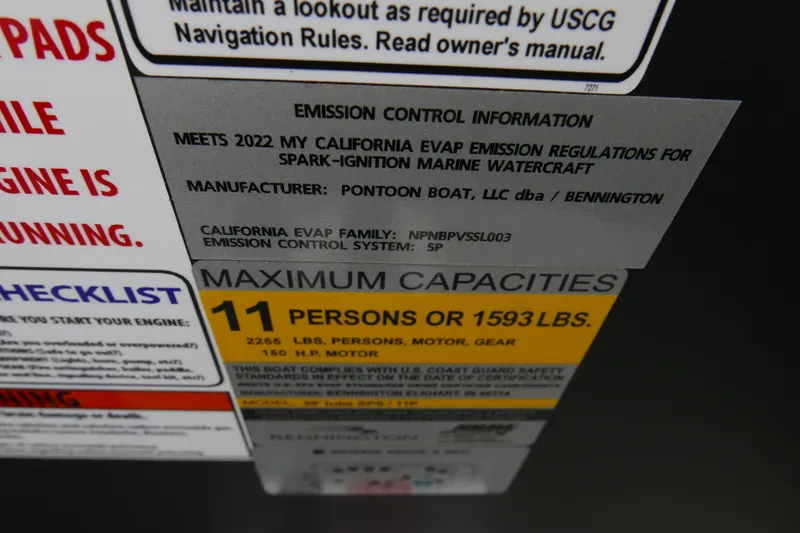 Slide: The Image of 2023 Bennington 21 SXSRC capacity label, 11 persons or 1593 lbs, emission compliance. - 14