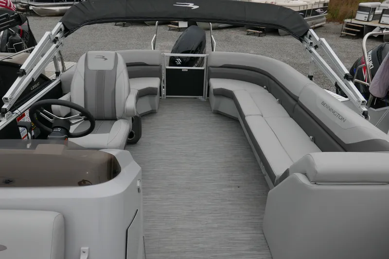 Slide: The Image of 2023 Bennington 21 SXSRC pontoon boat interior with gray seating and steering console. - 8