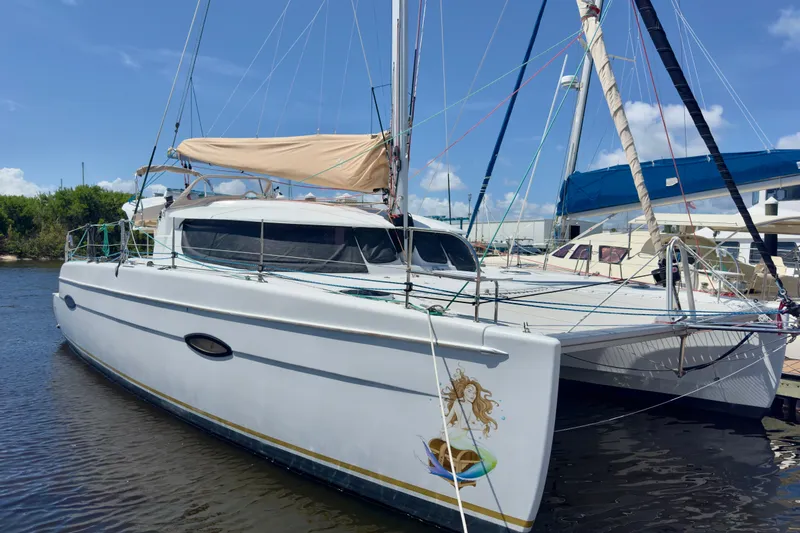 The Image of 2010 Fountaine Pajot Lipari 41 catamaran docked, featuring sleek design and vibrant graphics. - 0