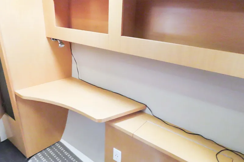 Slide: The Image of Interior of 2010 Fountaine Pajot Lipari 41 catamaran with wooden desk and shelving. - 23