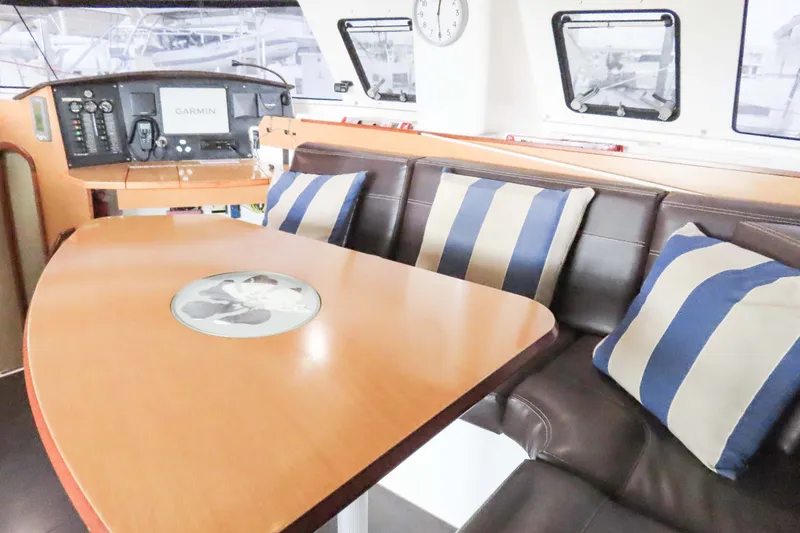 Slide: The Image of Interior of 2010 Fountaine Pajot Lipari 41 catamaran with striped cushions and navigation equipment. - 16