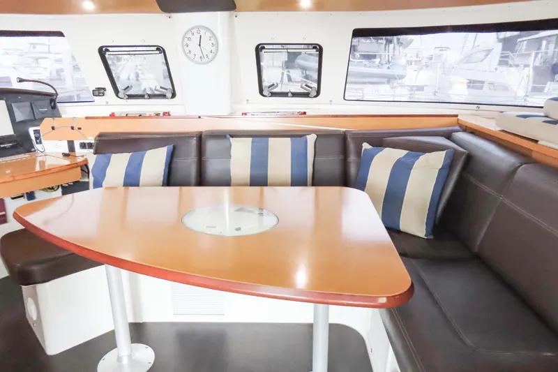 Slide: The Image of Interior of 2010 Fountaine Pajot Lipari 41 catamaran with cozy seating and striped cushions. - 17