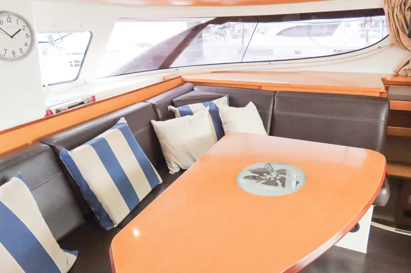 Slide: The Image of Interior of 2010 Fountaine Pajot Lipari 41 catamaran with cushioned seating and striped pillows. - 19
