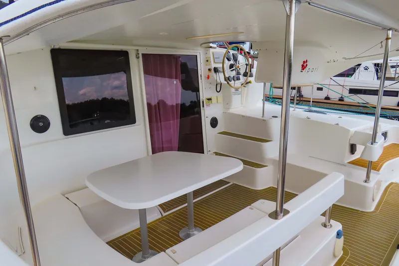 Slide: The Image of 2010 Fountaine Pajot Lipari 41 catamaran cockpit with seating, table, and helm station. - 8
