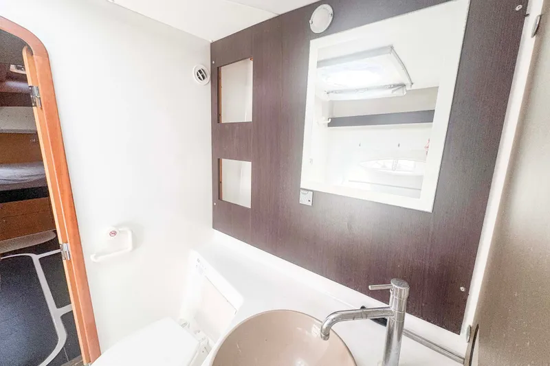 Slide: The Image of Bathroom interior of 2010 Fountaine Pajot Lipari 41 catamaran, featuring modern fixtures and mirror. - 26