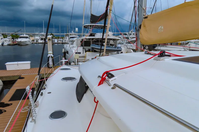 Slide: The Image of 2010 Fountaine Pajot Lipari 41 catamaran docked at marina under stormy skies. - 3