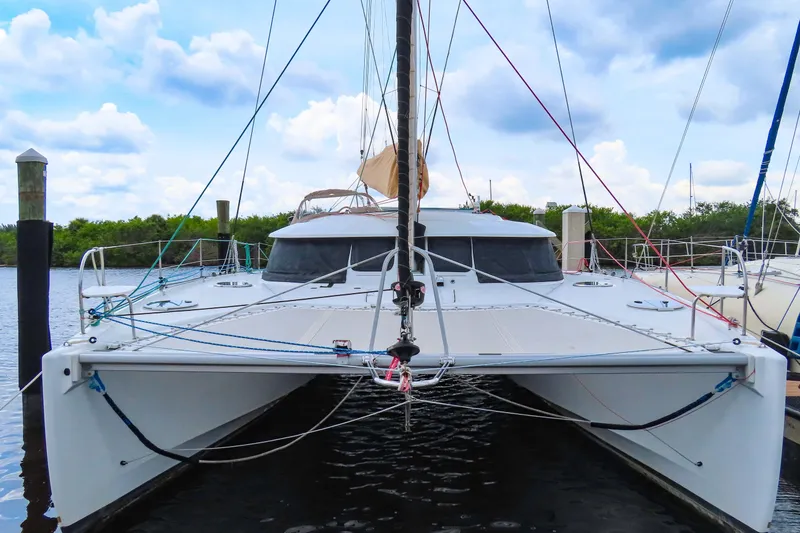 Slide: The Image of 2010 Fountaine Pajot Lipari 41 catamaran docked under a cloudy sky. - 1