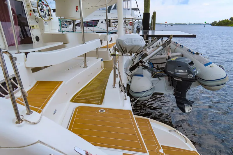 Slide: The Image of 2010 Fountaine Pajot Lipari 41 catamaran with Yamaha outboard motor and dinghy on deck. - 7