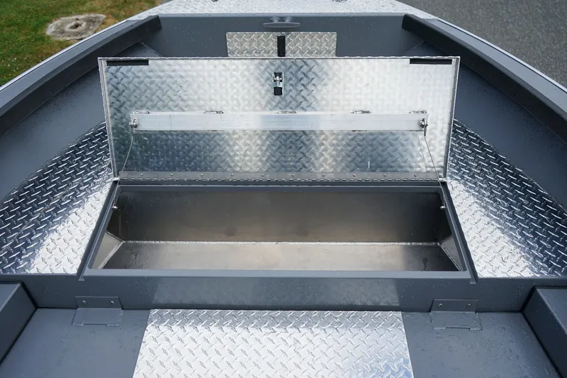 Slide: The Image of Open storage compartment on 2026 Alumaweld Super Vee 20 boat with diamond plate flooring. - 15