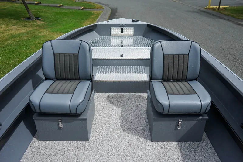 Slide: The Image of 2026 Alumaweld Super Vee 20 boat interior with two gray seats and diamond plate flooring. - 12