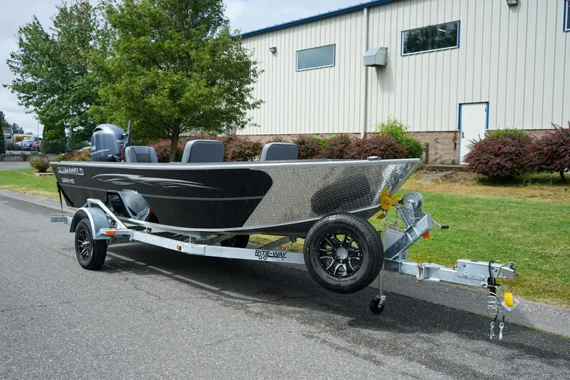 The Image of 2026 Alumaweld Super Vee 20 boat on trailer, parked outdoors near a building. - 1