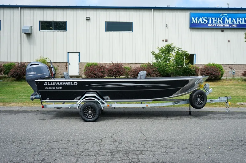 Slide: The Image of 2026 Alumaweld Super Vee 20 boat on trailer outside Master Marine Boat Center. - 2