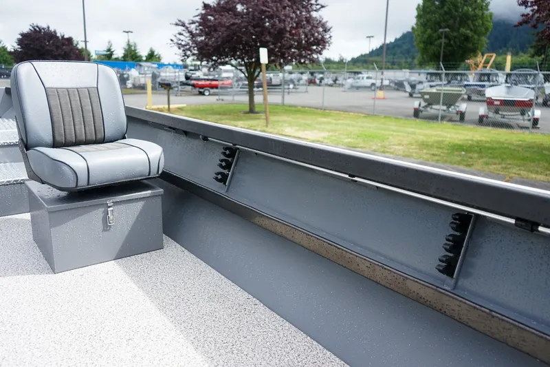 Slide: The Image of 2026 Alumaweld Super Vee 20 boat interior with gray seating and storage compartment. - 11