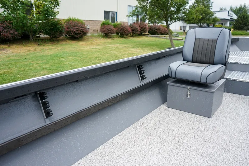 Slide: The Image of 2026 Alumaweld Super Vee 20 boat interior with gray seating and storage box. - 10