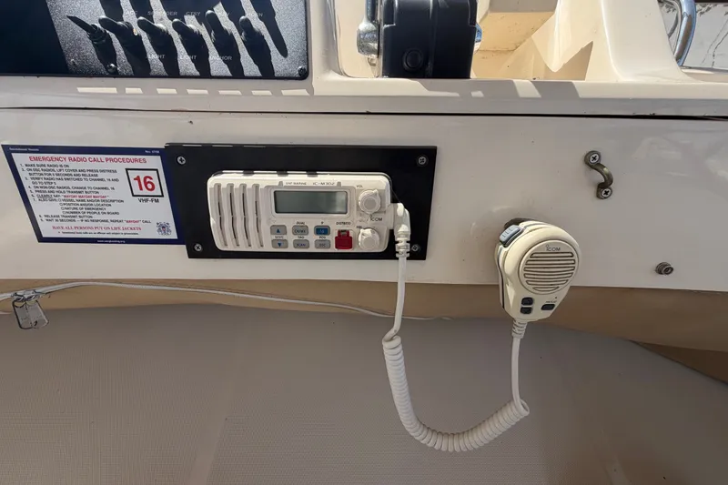 Slide: The Image of VHF marine radio setup on 2006 Mainship 34 Trawler with emergency call procedures. - 61