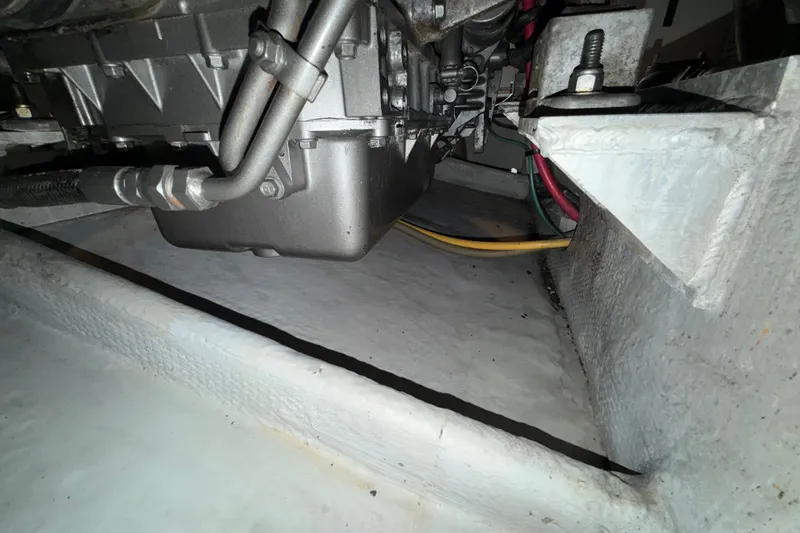 Slide: The Image of Engine compartment of a 2006 Mainship 34 Trawler, showing mechanical components and wiring. - 37