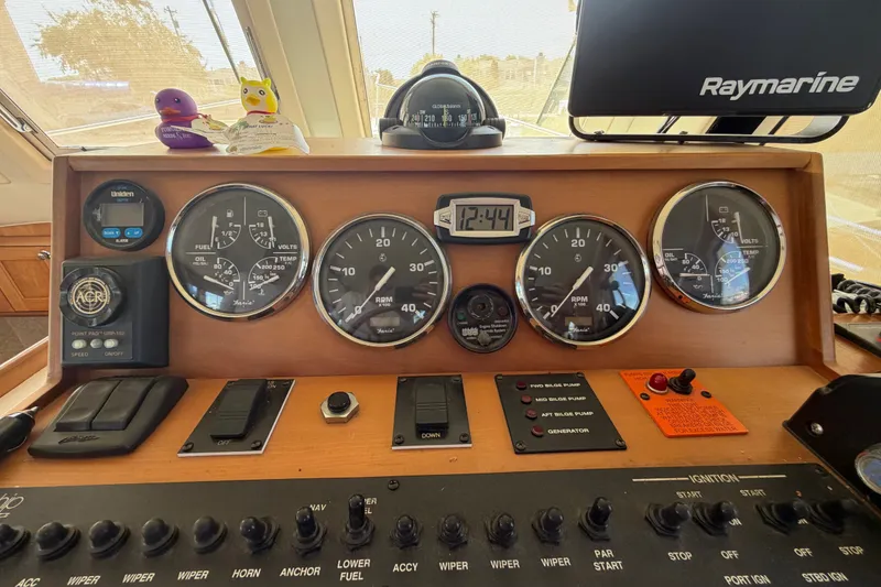 Slide: The Image of Control panel of a 2006 Mainship 34 Trawler with gauges and navigation equipment. - 80