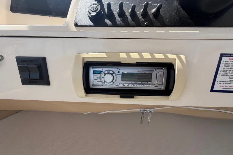 Slide: The Image of Control panel of a 2006 Mainship 34 Trawler featuring a Clarion stereo system. - 62