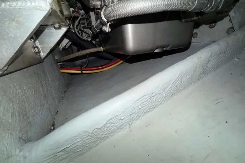Slide: The Image of Engine compartment of a 2006 Mainship 34 Trawler, showing wiring and components. - 38