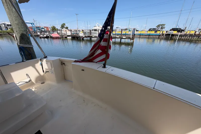 Slide: The Image of 2006 Mainship 34 Trawler deck with American flag, docked at marina. - 10