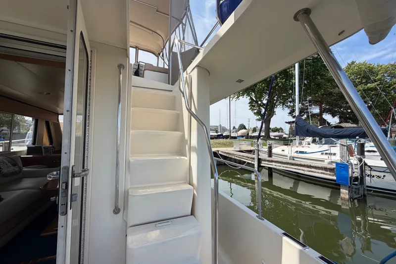 Slide: The Image of 2006 Mainship 34 Trawler interior with stairs, docked at marina. - 40
