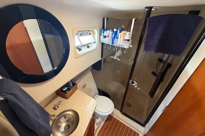 Slide: The Image of Bathroom interior of 2006 Mainship 34 Trawler with shower, sink, and toiletries. - 93