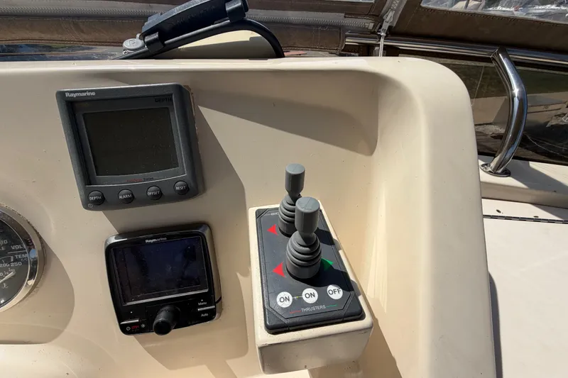 Slide: The Image of Control panel of a 2006 Mainship 34 Trawler with Raymarine displays and thruster controls. - 55