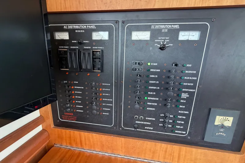 Slide: The Image of Electrical control panel on a 2006 Mainship 34 Trawler, featuring AC and DC distribution. - 71