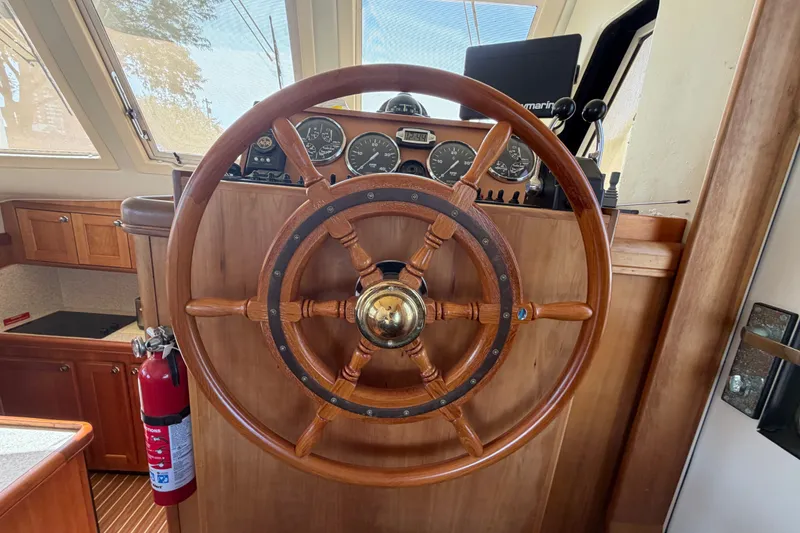 Slide: The Image of Steering wheel of a 2006 Mainship 34 Trawler with dashboard instruments. - 77