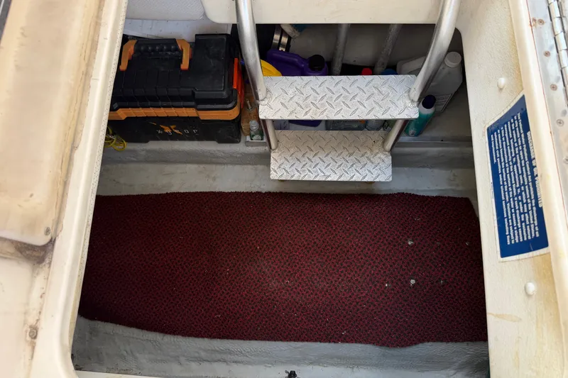 Slide: The Image of Engine compartment of a 2006 Mainship 34 Trawler with tools and maintenance supplies. - 19