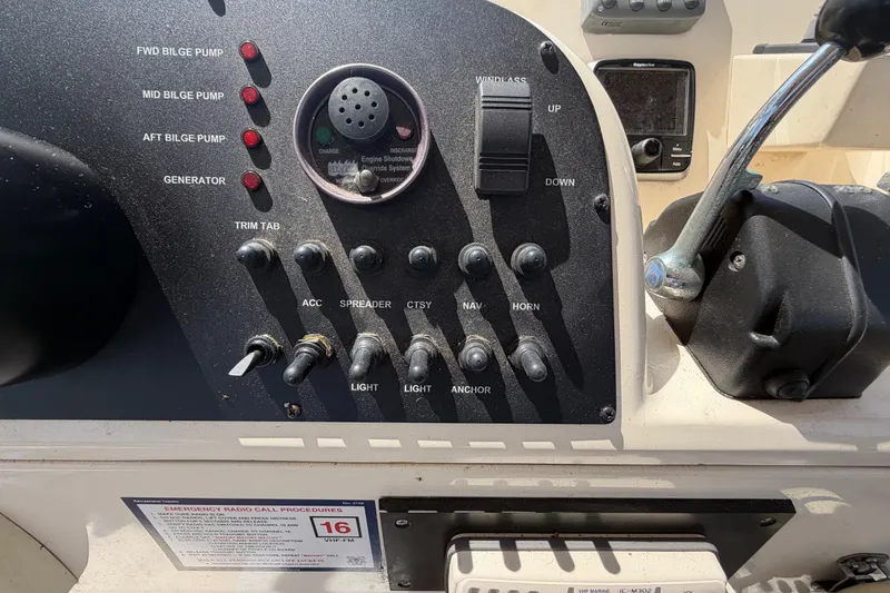 Slide: The Image of Control panel of a 2006 Mainship 34 Trawler with various switches and indicators. - 59